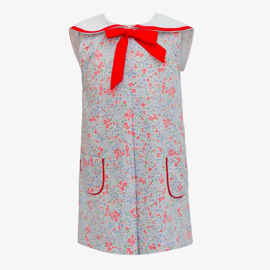 Add a touch of fun and style to your little one's wardrobe with our Floral Sailor Dress from Krewe Kids! This adorable dress features a vibrant floral pattern and a sailor style red bow collar, perfect for any occasion. Match with our Floral Sailor Bloomer Set for a cute sibling look!