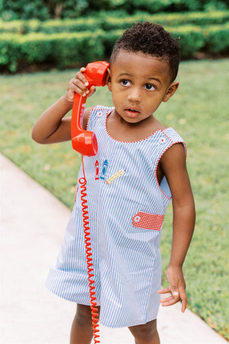 The Boys School Days Jon Jon from The Proper Peony combines classic blue and white stripes with charming embroidered crayons, making it an ideal outfit for memorable back-to-school preschool photos. Its playful design ensures your little one stands out with style and comfort on their special day.