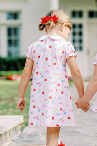 The Girls School Days Knit Dress by The Proper Peony combines comfort and charm with its soft knit fabric adorned with playful back-to-school prints. Featuring a classic white Peter Pan collar and adorable blue pockets, this dress is perfect for celebrating the new school year in style. Its cozy material ensures all-day comfort, making it an ideal choice for your little girl's busy days. Elevate her wardrobe with a dress that’s both practical and irresistibly cute.