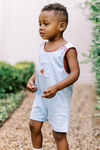Dress your little one for success with the Toddler Boys School Days Knit Jon Jon from The Proper Peony. Crafted from soft, light blue knit fabric, this charming outfit features red piping and a front pocket embroidered with a classic apple, perfect for his first day of preschool. Designed for comfort and style, it pairs beautifully with a peter pan collar shirt to create an effortlessly polished look. Make his school days memorable with this adorable and cozy Jon Jon.