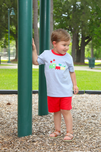 Transform your little boy's back-to-school excitement with this irresistible Trotter Street set! The blue and white striped tee showcases an adorable train applique hauling school supplies, perfectly paired with bright red shorts for a look that's both playful and stylish. Designed specifically for toddlers who love locomotives, this outfit will have your little conductor beaming with confidence as he chugs into the new school year. An absolute must-have for any train-loving tot!