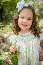 Load image into Gallery viewer, Brighten her wardrobe with the Girls Smocked Lemons Kate Dress from Shop Teeta. This charming dress features a delicate smocked neckline and a vibrant lemon print that captures playful summer style. The classic silhouette offers comfortable, easy movement—perfect for active little ones. Soft and versatile, it pairs beautifully with basics for everyday wear or dressed up for special occasions. A timeless addition to any girl's closet.
