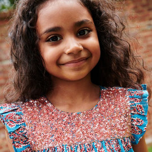The Girls Fiona Dress in Blue Paisley Sparkle offers a captivating blend of vibrant paisley patterns and subtle sparkle, perfect for making your little girl stand out. Designed for comfort and style, this dress allows easy movement while adding a touch of magic to any occasion. Whether for celebrations or everyday adventures, it’s a charming choice that brings elegance and playful shine to her wardrobe.
