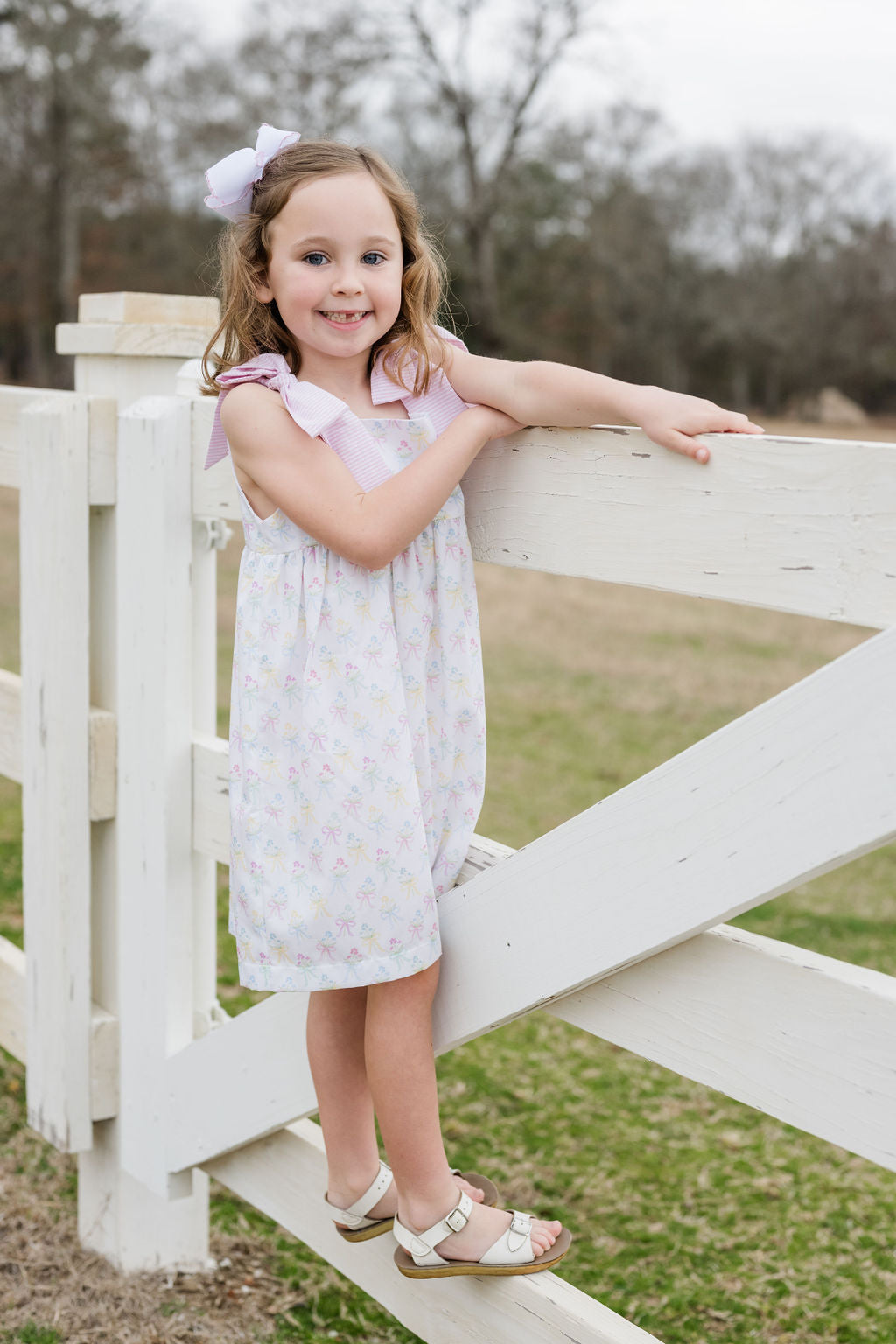 Indulge in the beauty of nature with Thea Flower Bouquet Dress from James & Lottie! Adorned with floral bouquets and cute bows, this dress exudes a sense of elegance. The pink and white seersucker ties on the shoulders add a charming touch. Perfect for any occasion, this dress will make you feel like a blooming flower!