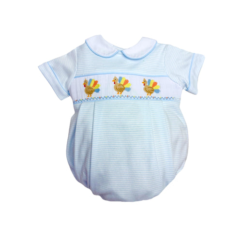 Dress your little one in playful charm with the Infant Boys Turkey Brandon Bubble from Zuccini Kids. Soft blue and white mini stripes create a gentle backdrop for the delightful smocked bubble, featuring colorful embroidered turkeys that add a whimsical touch. Comfortable and stylish, this bubble is perfect for keeping your infant cozy while standing out with unique, eye-catching details this Thanksgiving.