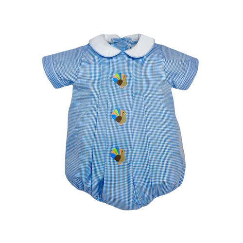 Dress your little one in timeless charm with the Infant Boy's Gingham Turkey Liam Bubble from Zuccini Kids. This festive outfit features a crisp blue and white gingham pattern, a delicate white Peter Pan collar, and a delightful turkey embroidery front and center. Perfect for Thanksgiving celebrations, it combines classic style with adorable holiday spirit, ensuring your baby stands out as the season's little star. Comfortable and cute, it’s the ideal choice for memorable family moments especially since the