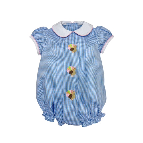 Dress your little one in timeless charm with the Infant Girls Gingham Turkey Sybil Bubble from Zuccini Kids. This festive outfit features a crisp blue and white gingham pattern, a delicate white Peter Pan collar, and a delightful turkey embroidery front and center. Perfect for Thanksgiving celebrations, it combines classic style with adorable holiday spirit, ensuring your baby stands out as the season's little star. Comfortable and cute, it’s the ideal choice for memorable family moments especially since th