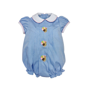 Dress your little one in timeless charm with the Infant Girls Gingham Turkey Sybil Bubble from Zuccini Kids. This festive outfit features a crisp blue and white gingham pattern, a delicate white Peter Pan collar, and a delightful turkey embroidery front and center. Perfect for Thanksgiving celebrations, it combines classic style with adorable holiday spirit, ensuring your baby stands out as the season's little star. Comfortable and cute, it’s the ideal choice for memorable family moments especially since th