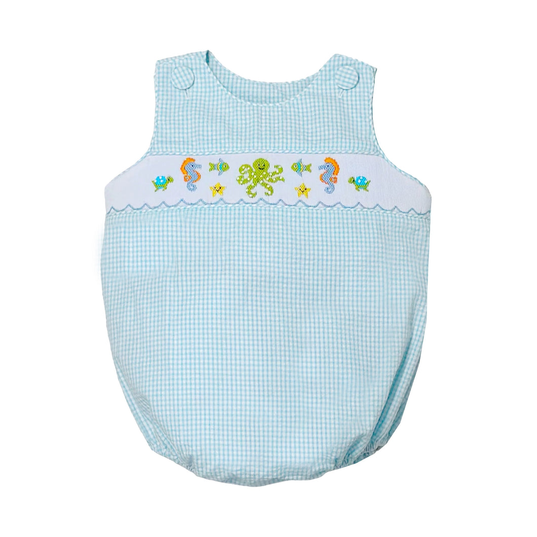 Dive into summer with the Infant Boy's Under The Sea Christopher Sunsuit from Zuccini Kids. This charming bubble features a refreshing teal and white check pattern complemented by an elegant smocked front adorned with delightful embroidered sea animals. This outfit transforms everyday play into magical underwater adventures. Perfect for beach outings, summer parties, or simply making a splash at daycare!