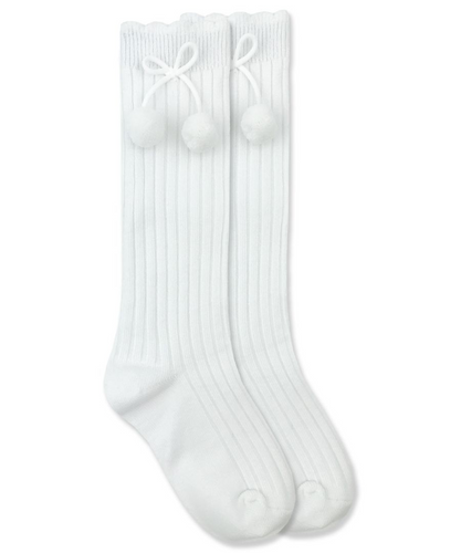 Add a touch of fun to any classic outfit with our White Knee-High Pom Pom Socks for girls from Jeffries Socks. Made with high-quality materials, these socks are comfortable and durable. Perfect for any occasion, these socks will keep your little one's feet cozy and stylish.