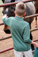 Load image into Gallery viewer, The Prodoh Pro Performance 1/4 Zip Pullover combines comfort and versatility for active boys. Crafted in a striking Camping Hedge Green Stripe, this pullover features a quarter-zip design for easy layering and temperature control. The performance fabric is designed to move with your child through outdoor adventures, playtime, and everyday wear.

Available in sizes 2T through 14, this sweatshirt transitions seamlessly from casual outings to more structured activities. The durable construction and timeless co
