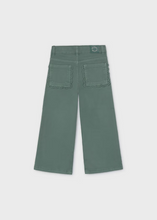 Load image into Gallery viewer, Effortless style meets playful design with these Girls Wide Leg Twill Pants in soft sage green. Crafted from quality twill, the relaxed wide-leg silhouette offers comfortable everyday wear, while charming pocket details add a whimsical touch that sets them apart. Layer with any sweater or blouse from the Mayoral or Pleat collections for a polished, coordinated look.
