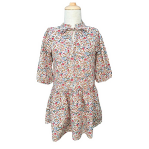 The Eve Dress in Jewel Floral by Pleat showcases a charming fall floral print with a flattering v-neck tie front and elegant drop waist. This dress is ideal for capturing beautiful fall photos and seamlessly transitions to suit any event throughout the season. Embrace effortless style and comfort with this versatile piece perfect for your autumn wardrobe.
