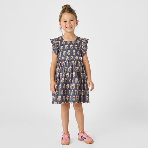 Get ready for spring with our Navy Flower Elsie Dress from Pink Chicken! Perfect for tween girls, this dress features a beautiful sleeveless floral pattern over a classic navy background. With charming ruffle sleeves, this dress will add a touch of elegance to any occasion.
