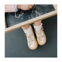 Load image into Gallery viewer, Meet the Emma Shimmer Bow T-Strap Mary Jane—the toddler shoe that effortlessly elevates any outfit. Featuring a charming bow detail and shimmering finish, this versatile style transitions seamlessly from everyday wear to special occasions. Crafted with breathable leather lining and a flexible outsole, it delivers all-day comfort without compromising on style. Perfect for parties, holidays, and everything in between, this Mary Jane is the go-to choice for parents seeking both polish and practicality in toddl
