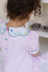 Celebrate the season in style with the Girl's Pink Christmas Tree Kendall Dress by Zuccini Kids. This charming light pink A-line dress features a delicate white peter pan collar with scalloped edges and intricate embroidery. Festive Christmas trees embroidered along the scalloped hem add a whimsical holiday touch, perfect for special occasions and holiday photos.&nbsp;