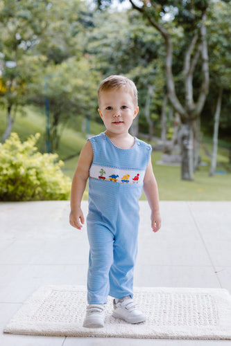Dress your little one in playful charm with the Infant Boy's Dino Festival Longall by Zuccini Kids. This smocked longall features crisp white and blue stripes, adorned with embroidered dinosaurs marching in a delightful parade. Crafted for comfort and style, it’s perfect for any occasion. Pair it with a peter pan collar tee on cooler days to keep your infant cozy and cute while exploring the world.