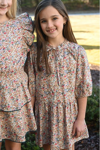 The Eve Dress in Jewel Floral by Pleat showcases a charming fall floral print with a flattering v-neck tie front and elegant drop waist. This dress is ideal for capturing beautiful fall photos and seamlessly transitions to suit any event throughout the season. Embrace effortless style and comfort with this versatile piece perfect for your autumn wardrobe.