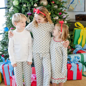 Dress your little one in holiday cheer with the Millie Girls' Lounge Pant Set from Lila &amp; Hayes. Crafted from soft, breathable pima cotton, this long-sleeved top and pant set features a charming Christmas Tree print that’s perfect for festive mornings. Delicate white piping around the neckline adds a touch of refinement, while the elastic waistband ensures a comfortable fit all day long. Ideal for cozy winter days, this set combines playful style with all-day comfort for your joyful holiday moments.