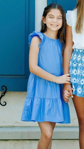 Transform your tween's spring wardrobe with our Layla Dress in Lapis Blue from Pleat! Featuring a flattering ruffle cap sleeves and a tiered skirt, this dress exudes charm and femininity. Elevate her style with this must-have piece!