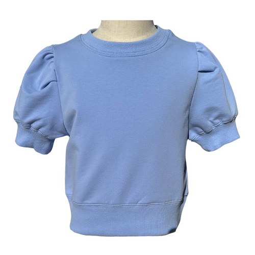 The Riley Sweatshirt in Cornflower is a charming short-sleeve top featuring stylish puffed shoulders that add a playful touch to any tween girl's wardrobe. Crafted from comfortable sweatshirt material, it offers a cozy feel perfect for crisp fall days. Pair it effortlessly with tiered pleat skirts to create a fashionable, coordinated look your child will love wearing throughout the season.
