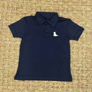 Get your son ready for Summer with this Boys Navy Polo featuring a cute white puppy logo from James &amp; Lottie. Made for boys of all ages, it pairs perfectly with any shorts for a stylish and adorable outfit. Perfect for any Summer celebration or casual day out!