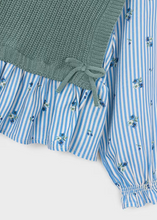 Load image into Gallery viewer, Layered elegance meets everyday versatility in this charming combination top from Mayoral. The sage green sweater vest drapes beautifully over a delicate floral print blouse, complete with adjustable side ties for a custom fit. Soft, quality construction makes it ideal for layering through the seasons—wear it to school, special occasions, or anywhere in between.

