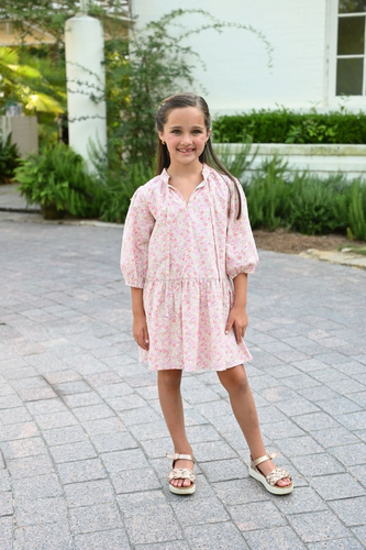 Elevate her spring wardrobe with the Eve Dress in Sweet Tart from Pleat! Featuring a stunning floral print, dropped waist, and puffy sleeves, this dress adds elegance to cooler days. Perfect for tween girls who want to look stylish and chic.