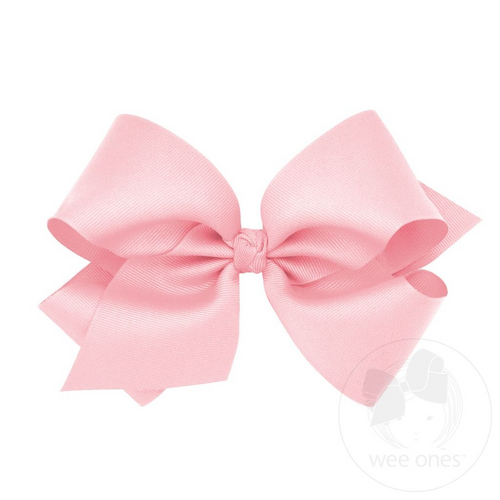 Elevate any outfit with this darling Light Pink Grosgrain Bow from Wee Ones. Made from high-quality grosgrain material, this classic bow will add a touch of sweet charm to any look. Available in multiple sizes, it's the perfect accessory to complete your little one's wardrobe. Order now and add a pop of pink to her style!