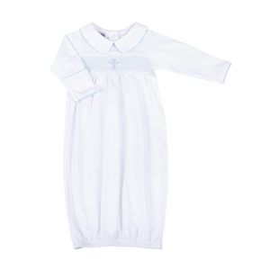 Dress your little girl in divine style with our Blessed Blue Smocked Collared Gown from Magnolia Baby. This infant gown features a delicate collar with enchanting embellishments and smocked detailing on the chest, including a sweet blue cross. Give your little angel a blessed look on any occasion.