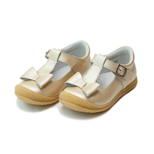 Load image into Gallery viewer, Meet the Emma Shimmer Bow T-Strap Mary Jane—the toddler shoe that effortlessly elevates any outfit. Featuring a charming bow detail and shimmering finish, this versatile style transitions seamlessly from everyday wear to special occasions. Crafted with breathable leather lining and a flexible outsole, it delivers all-day comfort without compromising on style. Perfect for parties, holidays, and everything in between, this Mary Jane is the go-to choice for parents seeking both polish and practicality in toddl
