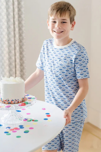 Celebrate his special day in style with the Charles Boys' Short Set in Birthday Cake Blue from Lila & Hayes. This playful pajama and loungewear set combines comfort and fun, making it perfect for birthday celebrations or everyday wear. Crafted with soft, breathable fabric, it keeps him cozy while adding a festive touch to his wardrobe. Make his birthday memorable with a set designed to delight both kids and parents alike.