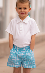 Introducing the Boys Patrick Polo in White from The Yellow Lamb. This classic white polo is the perfect addition to your child's Spring and Summer wardrobe. With its timeless style and versatile pairing options, it's a must-have for any young fashionista. Stay stylish and comfortable with this essential piece.