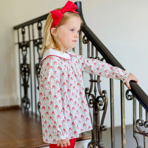 Dress your little one in festive charm with the Morgan Set Girls' Legging Set - Nutcracker Ballet by Lila & Hayes. This playful print tunic & leggings outfit features a whimsical nutcracker ballet print with a classic Peter Pan collar, perfectly paired with vibrant red leggings. Designed for comfort and style, this set brings joyful holiday spirit to any occasion while allowing your child to move and play freely. Make holiday moments memorable with this delightful ensemble.