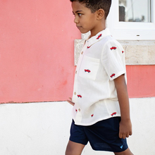 Load image into Gallery viewer, This soft muslin Vintage Car Embroidered Shirt from Blue Rooster is a must-have for boys who love classic cars. The button up design and classic collar add a touch of sophistication, while the embroidered cars bring a fun and unique element to this shirt. Perfect for any young car enthusiast! Pair with our Boys Jackson Short for a versatile look that works for school days, neighborhood games and a family outings alike.&nbsp;
