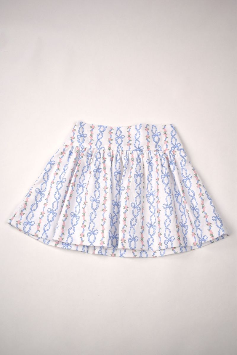 This Girls Bow Print Skirt from Funtasia Too! is a must-have for your little one's wardrobe. The adorable classic blue bow design adds a touch of charm to any outfit. Pair it with the Angel Sleeve Tee for a complete and stylish look.

Pre-Order: Arriving Spring 2025!