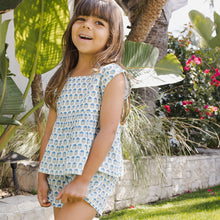 Load image into Gallery viewer, Shorts And Sweet! The Girls Kamari 2-Piece Set adds an easy to wear elastic waist bottom, adorned with a faux pattern on pattern tie, to our already well loved breezy Kamari top. The boxy fit, sleeveless top features a square neckline and a silver glitter button keyhole closure at the back. This fresh ensemble embodies our free spirted summer attitude and is perfect for all sorts of adventures, indoors and out.
