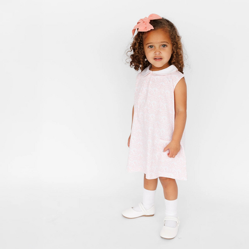 The Girl's Pink Scallop Pocket Twirl Dress blends elegance and playful charm, ideal for everyday adventures, imaginative play, and joyful occasions.  

Classic and charming style.
Perfect for playtime, parties, and special moments.
Pima Cotton