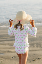 Load image into Gallery viewer, Get ready to make a splash with our Girly Fish Rash Guard One Piece Swimsuit! Designed by Funtasia Too, this adorable swimsuit features a cute pink and green fish design on a white background. The rash guard style and ruffle waist accent make it both stylish and practical for your little one. Dive in now!
