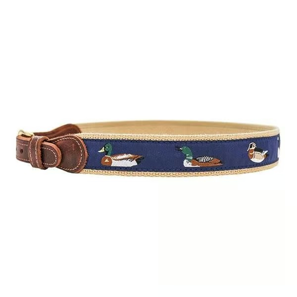 Elevate your boy’s style with the Water Fowl Boys Belt by J. Bailey. This woven belt showcases charming nylon water fowl patterns against a navy background, paired with a sleek leather and gold closure for a timeless look. Perfect for adding a classic touch to any outfit, it’s a durable and stylish accessory designed to complement your young gentleman’s wardrobe effortlessly.