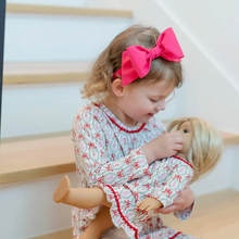 Load image into Gallery viewer, Dress your little one in enchanting elegance with the Carlin Girls&#39; Dress featuring a charming Nutcracker Ballet print from Lila &amp; Hayes. Made from soft, breathable long-sleeve pima cotton, it ensures comfort all day. The flutter ruffle hem and delicate pom pom trim add playful details, while the button closure at the back makes dressing effortless. Perfectly pairs with the matching Doll Dress for an adorable coordinated look that captures the magic of the season.
