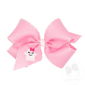 King Grosgrain Hair Bow with Moonstitch Edge and Pink Ghost Embroidery. Features a cute bow wearing ghost on the ribbon. Pairs with our Halloween pink looks this season! From Wee Ones.