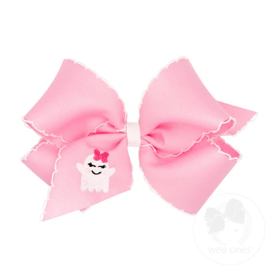 King Grosgrain Hair Bow with Moonstitch Edge and Pink Ghost Embroidery. Features a cute bow wearing ghost on the ribbon. Pairs with our Halloween pink looks this season! From Wee Ones.