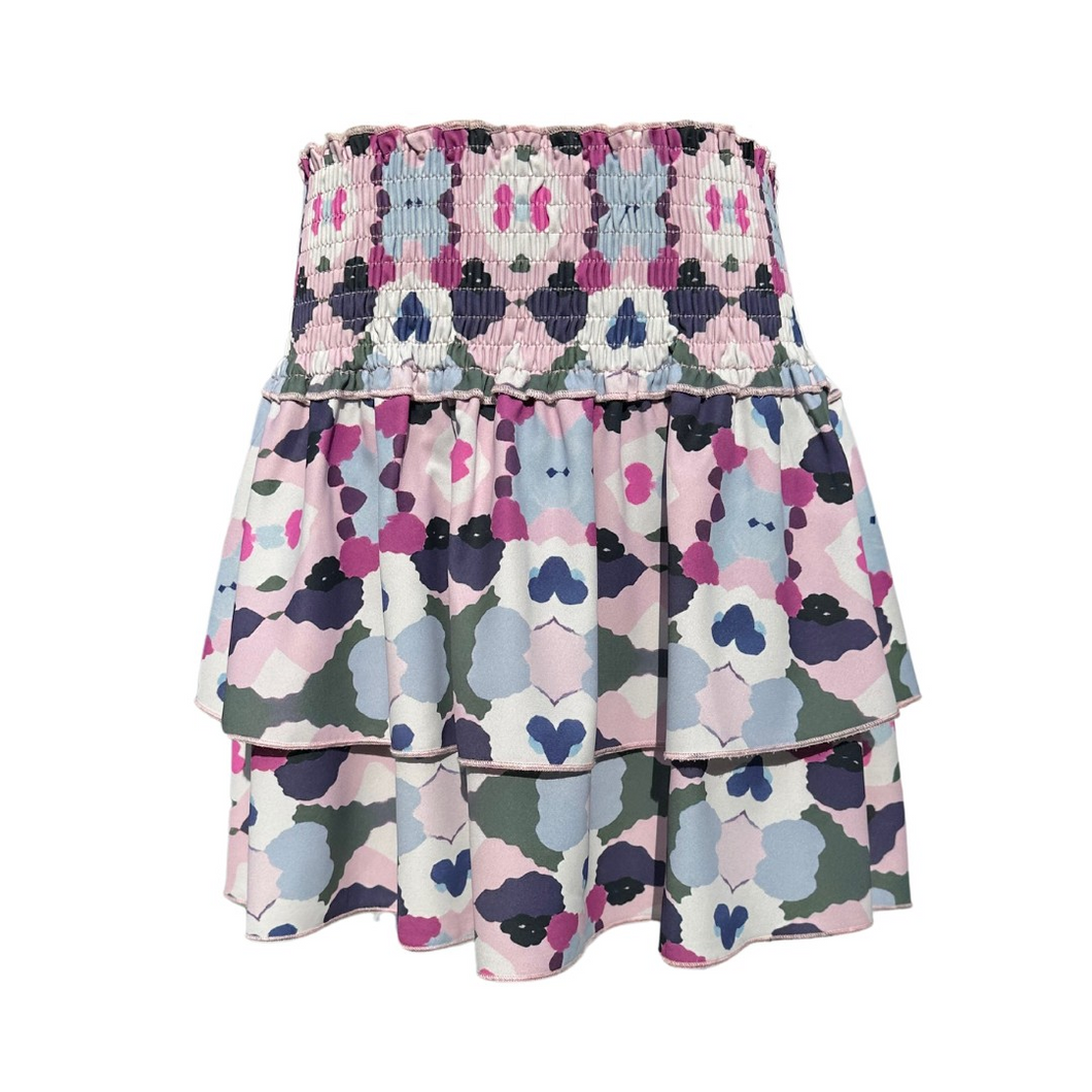 The Scottie Skirt in Ink Blot offers tween girls a stylish and comfortable tiered design with a stretchy waist for easy wear. Its playful pattern pairs effortlessly with matching pleat tops, making it a versatile choice for both casual days and special outings. Perfect for layering style and comfort in one charming skirt.