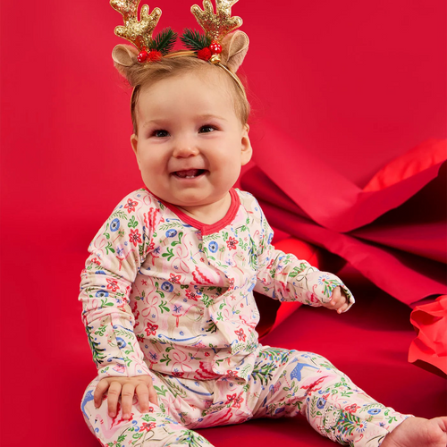 The Sugar Plum Dreams Convertible Footie makes bedtime effortless with a magnetized top that opens swiftly for easy, diaper changes and dressing. Crafted from durable modal fabric, these pajamas offer a silky soft feel and comfortable stretch. Featuring a charming and sophisticated Christmas holiday print, they combine style with sustainability for cozy nights. Feet convert to full footie to keep her cozy and warm all night.