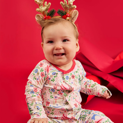 The Sugar Plum Dreams Footie makes bedtime effortless with a magnetized top that opens swiftly for easy, independent dressing. Crafted from durable modal fabric, these pajamas offer a silky soft feel and comfortable stretch. Featuring a charming and sophisticated Christmas holiday print, they combine style with sustainability for cozy nights.