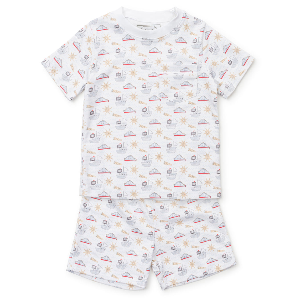 Get ready for bedtime adventures with our Pirates 2- Piece Short Sleeve Pajama Set from Lila & Hayes! This adorable set features a short sleeve shirt and shorts, both adorned with playful pirate designs and ships. Your little one will drift off to sleep feeling like a swashbuckling adventurer!