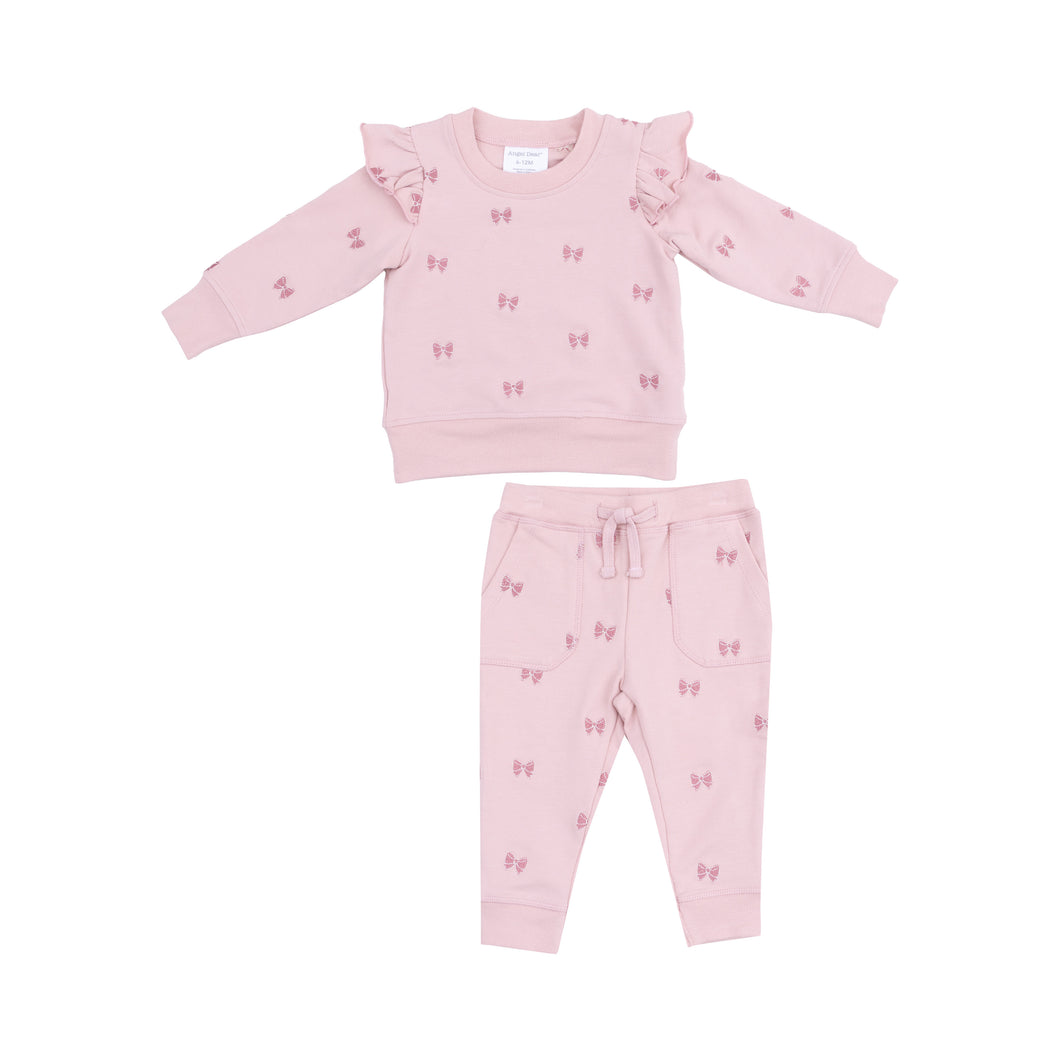 Pamper your little princess in the charming Bows French Terry Ruffle Sweatshirt and Jogger from Angel Dear. Made with cozy french terry fabric, this outfit is adorned with delightful embroidered bows for a touch of sweetness. Perfect for keeping your little one stylish and comfortable.