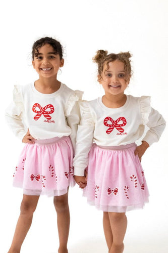Celebrate the season in style with the Candy Canes Ruffle Shoulder French Terry Sweatshirt from Angel Dear. This cozy sweatshirt features charming ruffle details on the shoulders, adding a festive touch to your little one's wardrobe. Made from soft French terry fabric, it ensures comfort during holiday playtime. Pair it with the matching Candy Canes Tutu Skirt for an adorable and playful holiday outfit that will make your child the star of any celebration. 