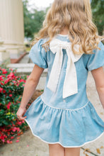 Load image into Gallery viewer, The Harper Dress captures effortless elegance in sumptuous Beaufort blue velvet. Designed for girls ages 5–8, this charming piece features an oversized back bow—a subtle yet striking detail that elevates any occasion. Whether she's attending a fall celebration or holiday gathering, the luxurious velvet drape and thoughtful silhouette make this dress a wardrobe essential. A timeless choice for special moments.
